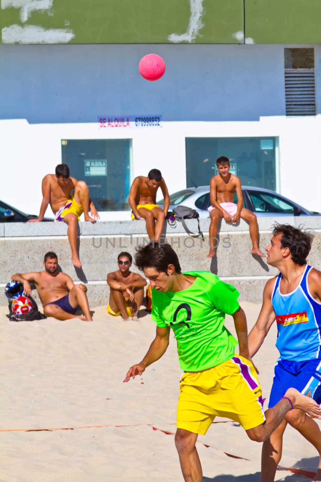 CADIZ, SPAIN - JULY 19: Unidentified players compete in a match between Zonabalonmano.com and BMPY Los Coñetas in the 19th league of beach handball of Cadiz on July 19, 2011 in Cadiz, Spain
