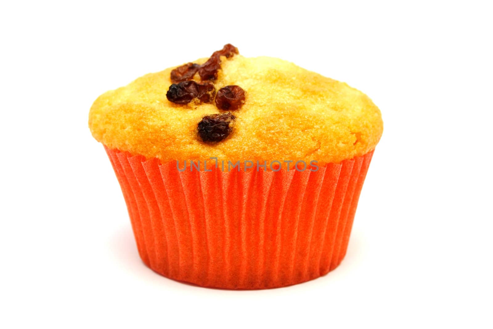 Zoomed tasty yellow muffin with many brown raisins