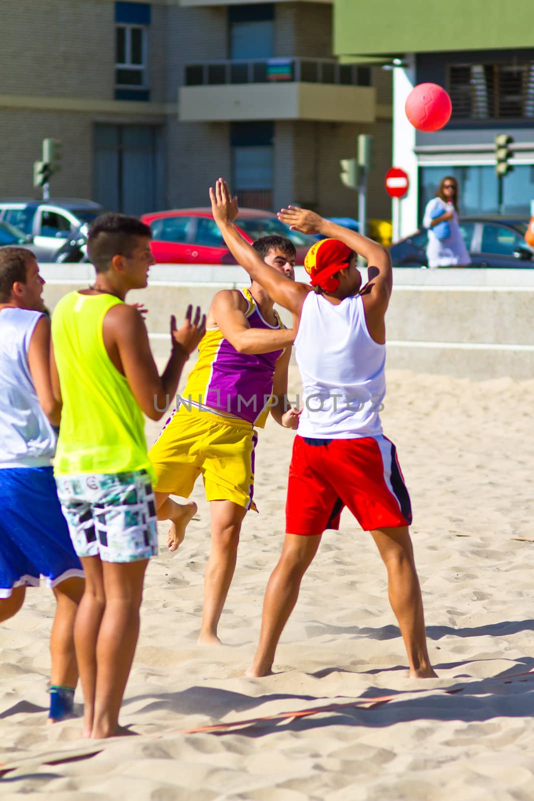 CADIZ, SPAIN - JULY 19: Unidentified players compete in a match between Los Negritos and Ademar Adentro in the 19th league of beach handball of Cadiz on July 19, 2011 in Cadiz, Spain