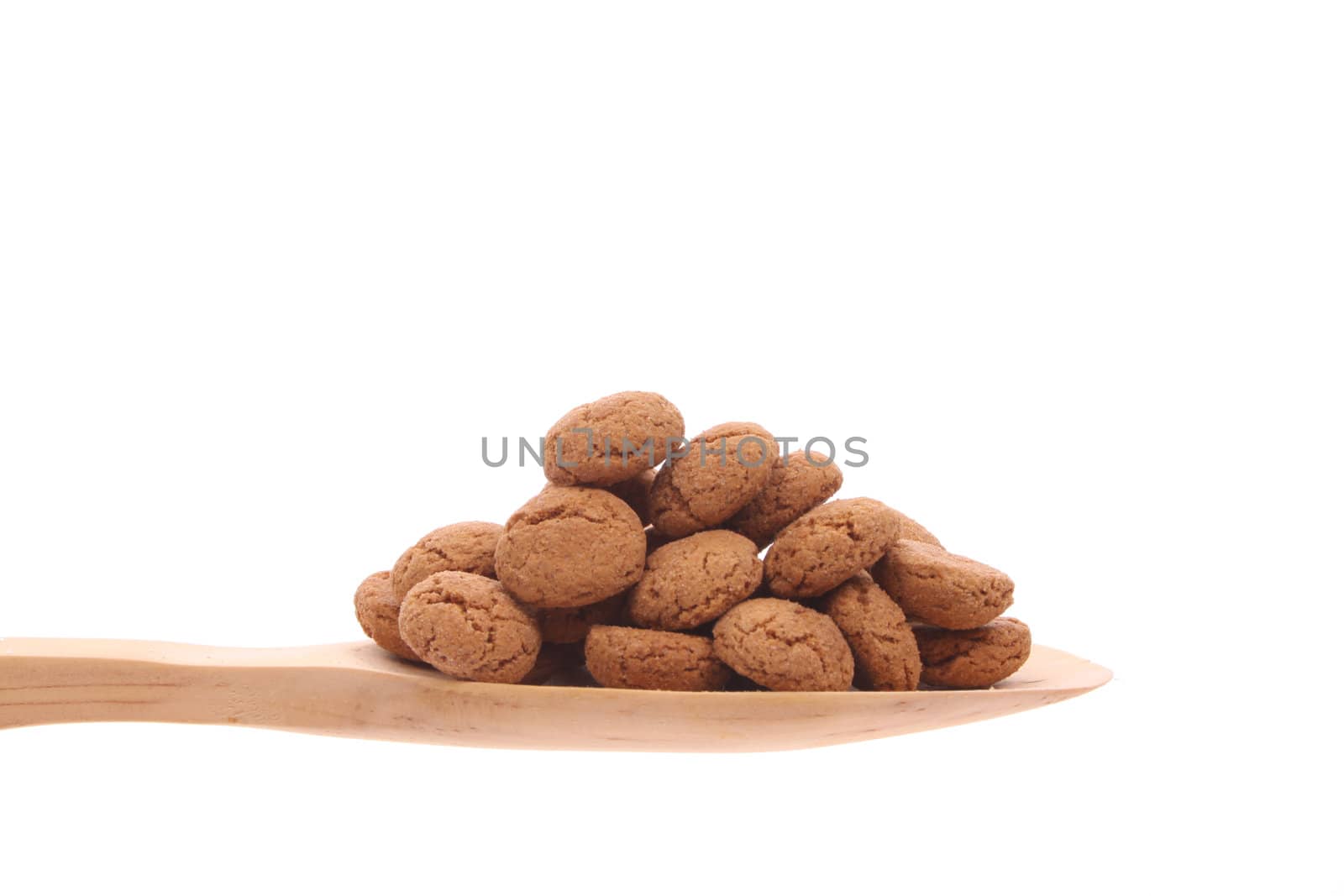 Spice-nuts simply offered on a wooden spoon isolated on a white background 