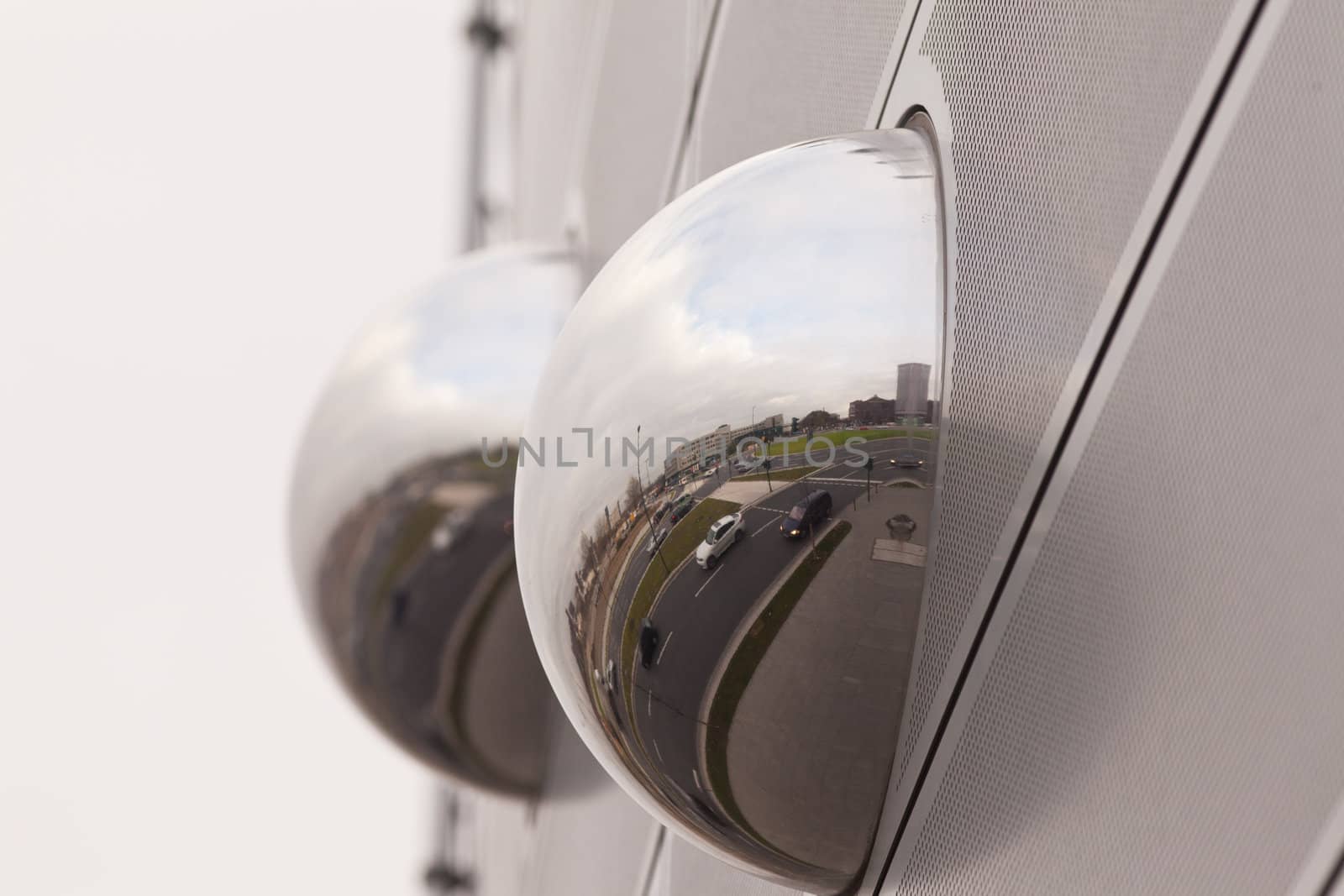 Cityscape reflection in metal sphere facade detail by PiLens