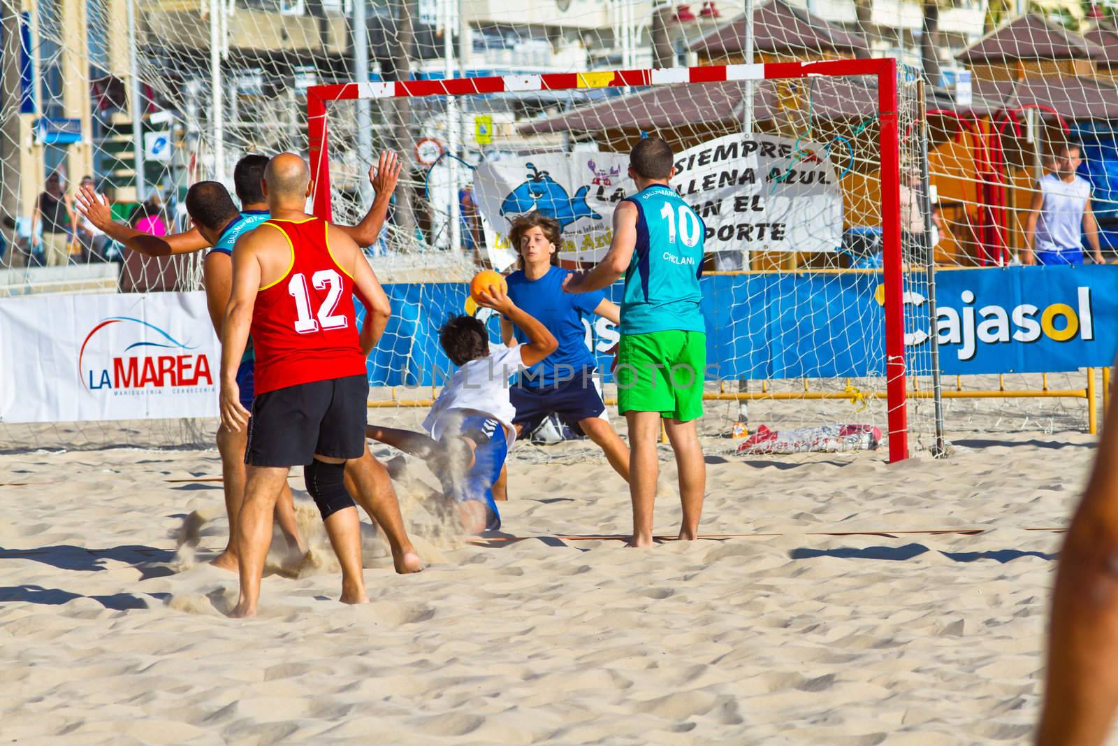 CADIZ, SPAIN - JULY 19: Unidentified players compete in a match between BMPY LAM Chiclana and Los Legendarios in the 19th league of beach handball of Cadiz on July 19, 2011 in Cadiz, Spain