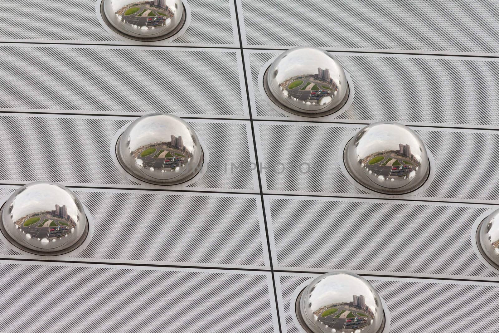 Cityscape reflection in metal sphere facade detail by PiLens