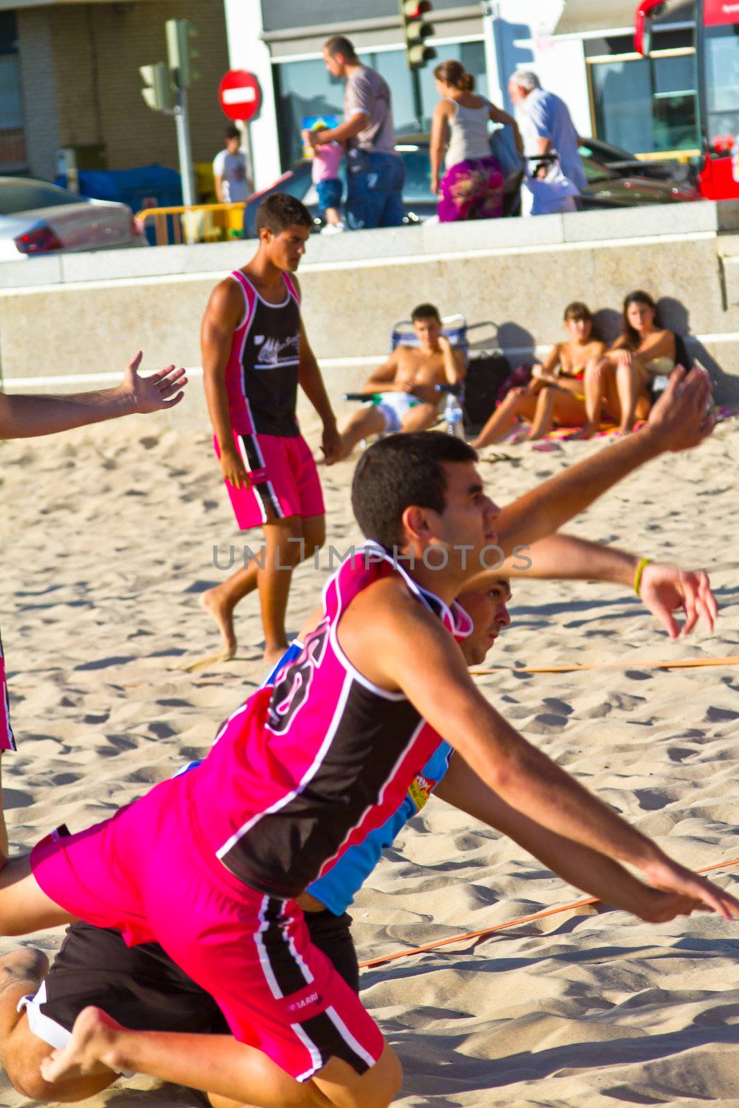 CADIZ, SPAIN - JULY 19: Unidentified players compete in a match between Zonabalonmano.com and CadizSur Seguros BMPY in the 19th league of beach handball of Cadiz on July 19, 2011 in Cadiz, Spain