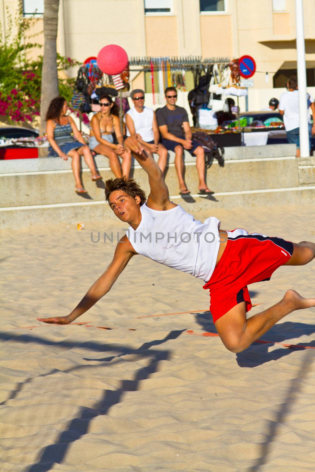 CADIZ, SPAIN - JULY 19: Unidentified players compete in a match between Los Negritos and Autoescuela Barquin in the 19th league of beach handball of Cadiz on July 19, 2011 in Cadiz, Spain