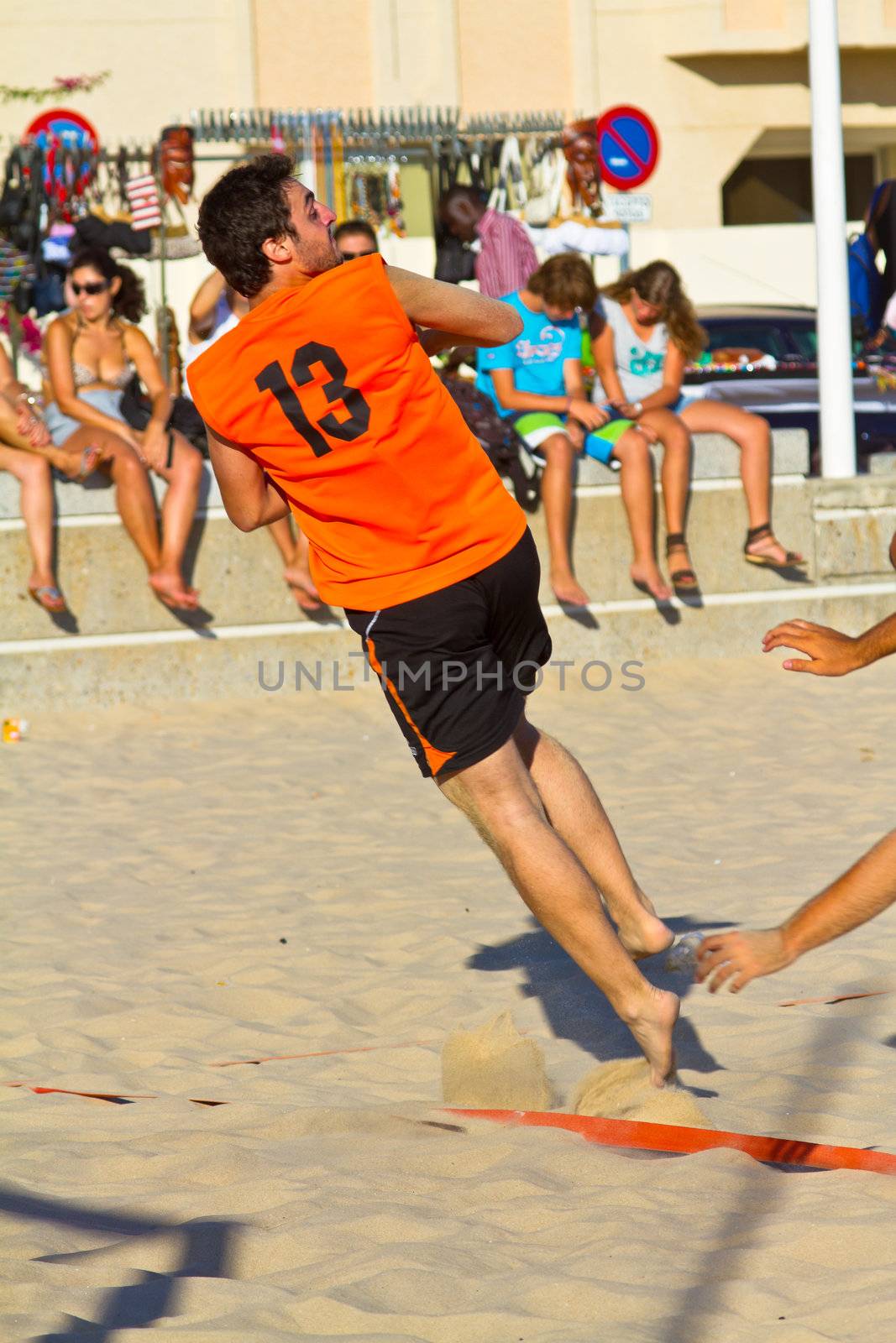 CADIZ, SPAIN - JULY 19: Unidentified players compete in a match between Los Negritos and Autoescuela Barquin in the 19th league of beach handball of Cadiz on July 19, 2011 in Cadiz, Spain