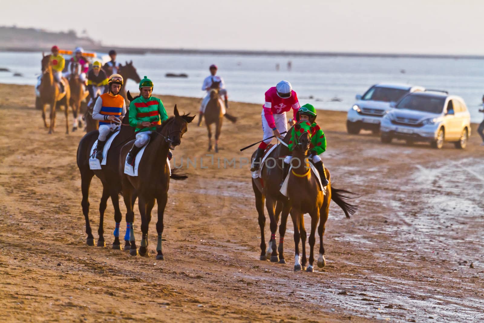 SANLUCAR DE BARRAMEDA, CADIZ, SPAIN - AUGUST 10: Unidentified riders at the start of race horses on Sanlucar de Barrameda beach on August 10, 2011 in Sanlucar de Barrameda, Cadiz, Spain.