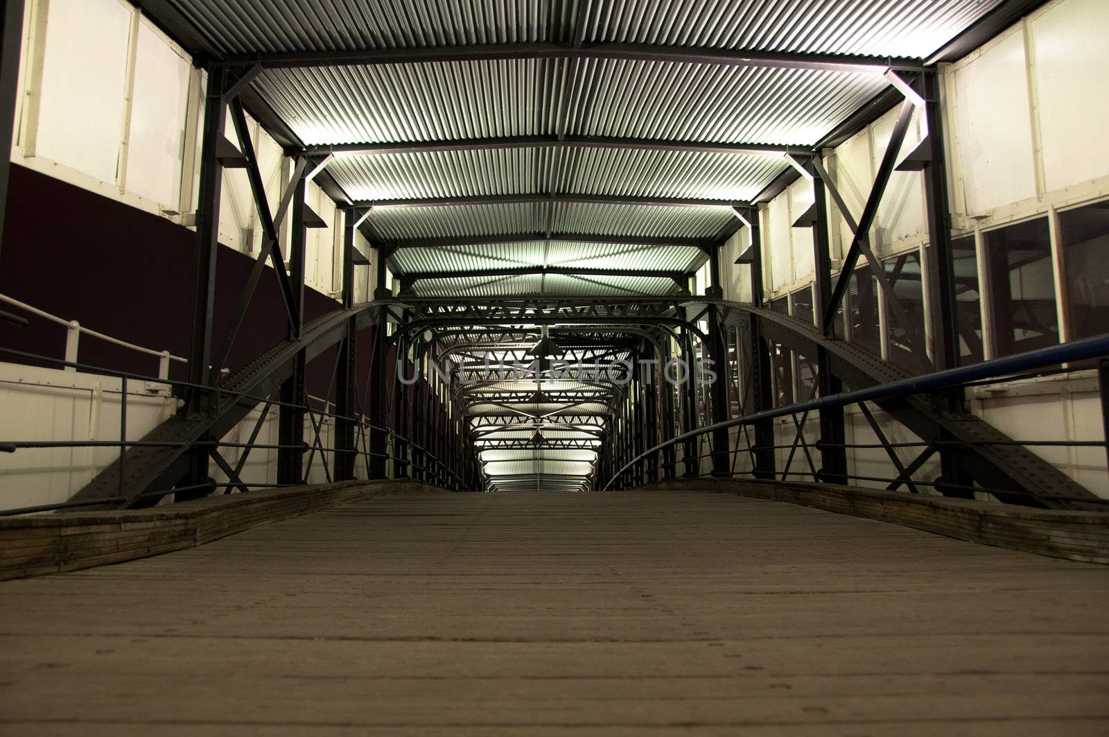 vanishing metal hallway leading to a ship in Hamburg harbor