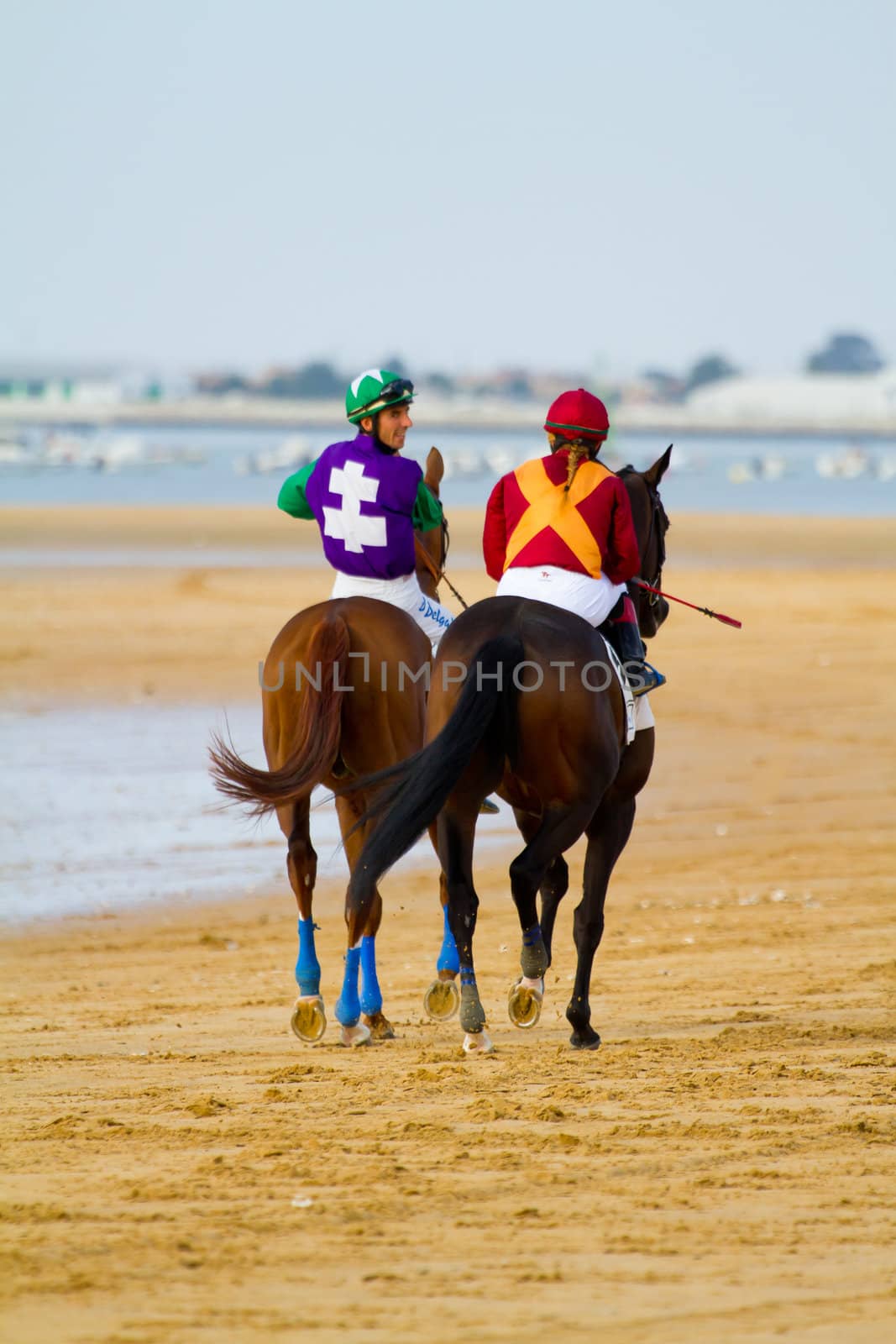 SANLUCAR DE BARRAMEDA, CADIZ, SPAIN - AUGUST 11: Unidentified riders at the start of race horses on Sanlucar de Barrameda beach on August 11, 2011 in Sanlucar de Barrameda, Cadiz, Spain.