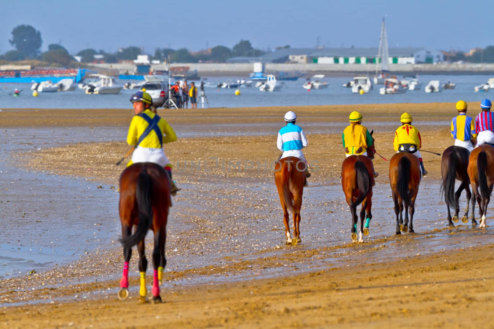 SANLUCAR DE BARRAMEDA, CADIZ, SPAIN - AUGUST 11: Unidentified riders at the start of race horses on Sanlucar de Barrameda beach on August 11, 2011 in Sanlucar de Barrameda, Cadiz, Spain.