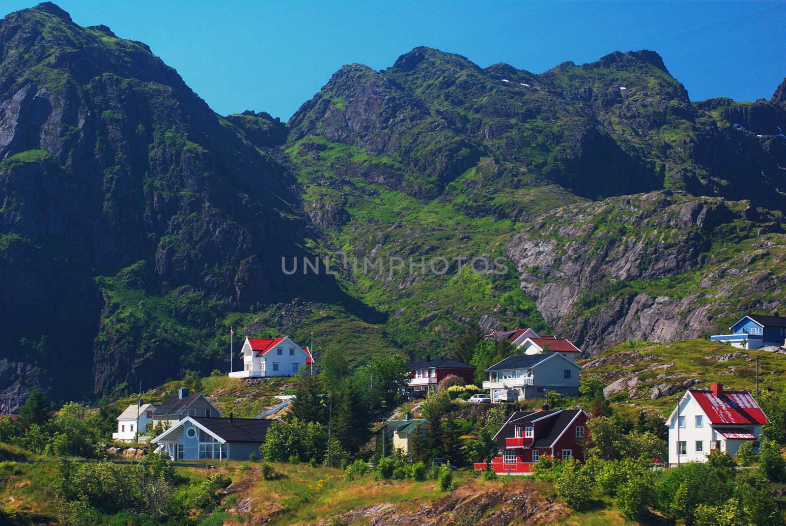 Small settlement in between ruuged mountain scenery on the Lofoten Islands (Norway)