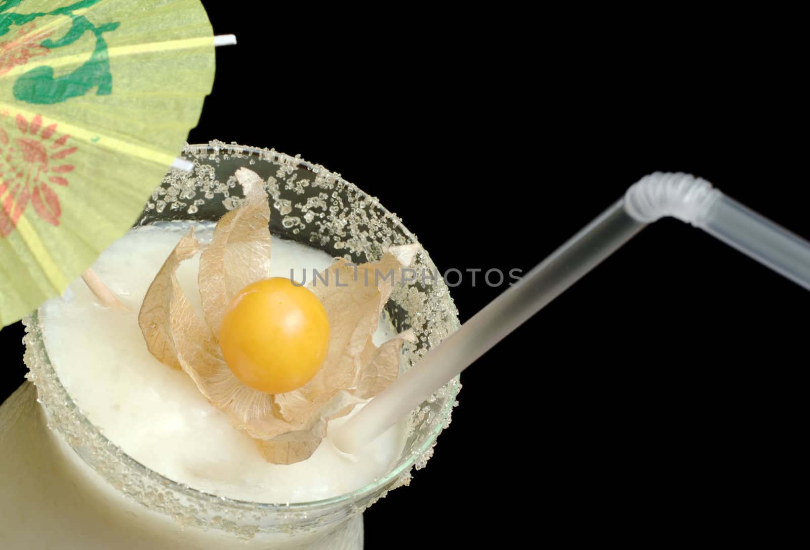 Guanabana Smoothie with a physalis and a paper sunshade as decoration from top from close