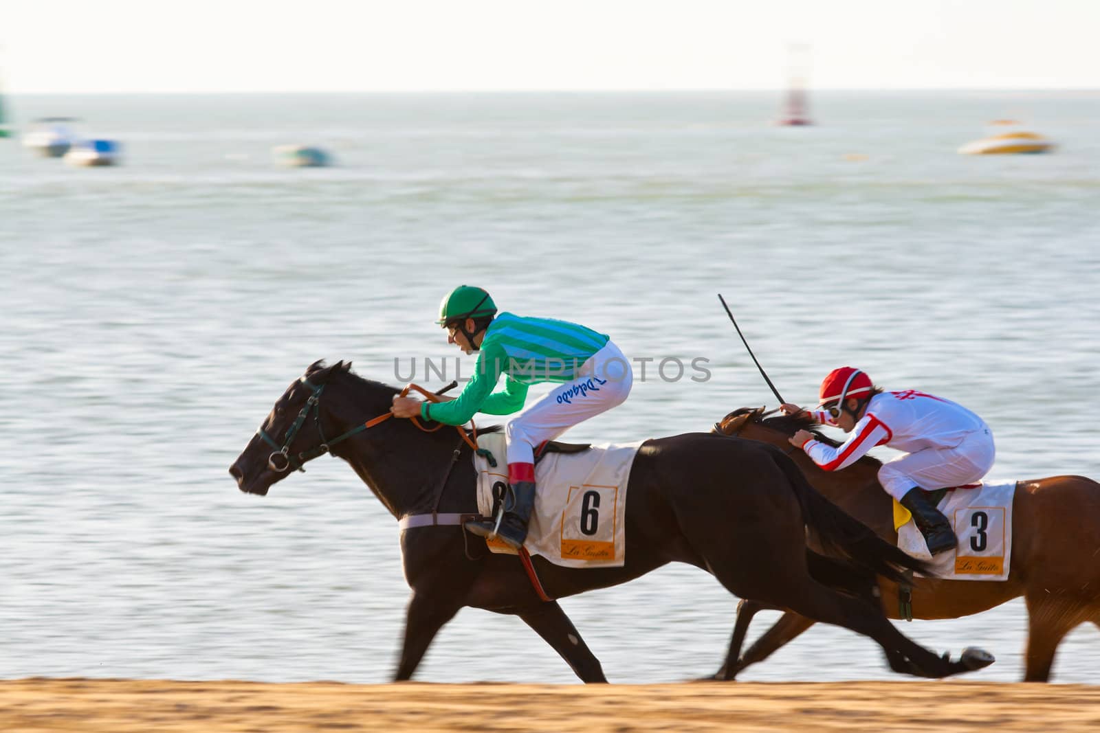 SANLUCAR DE BARRAMEDA, CADIZ, SPAIN - AUGUST 07: Unidentified riders race horses on Sanlucar de Barrameda beach on August 28, 2008 in Sanlucar de Barrameda, Cadiz, Spain.