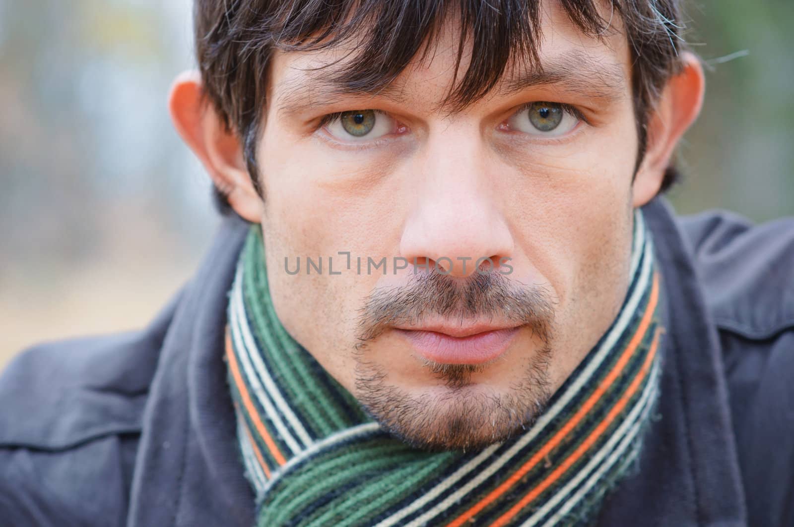 Portrait of nice young man on background of nature sunny day