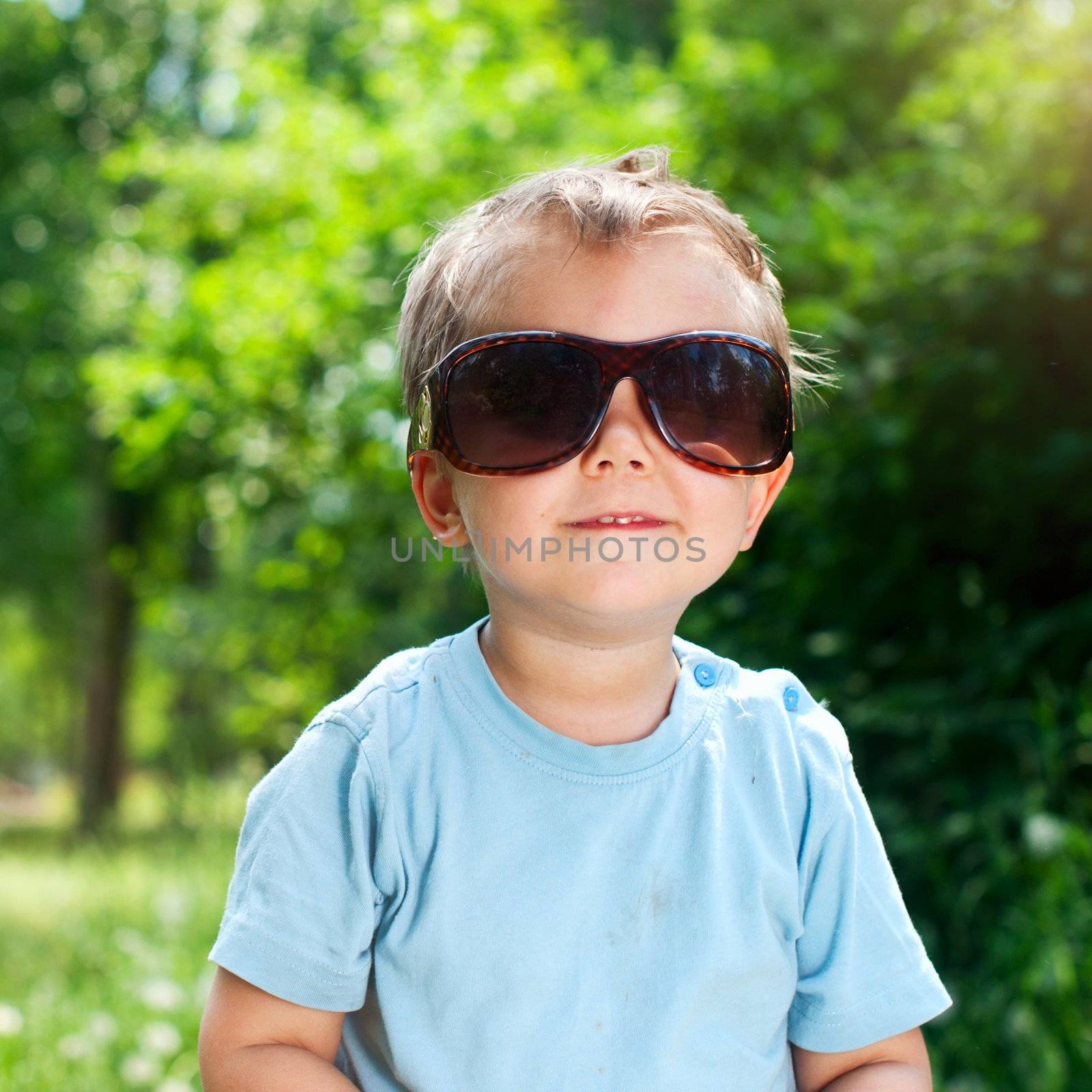 Cute 2 years old boy Sunglasses outdoors at sunny summer day