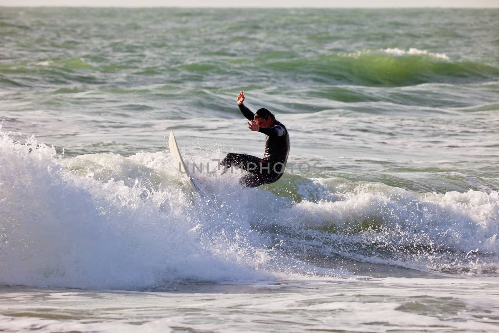 SAN FERNANDO, CADIZ, SPAIN - FEB 19: Unknown surfer taking waves on the 2nd championship of Surf and BodyBoard Impoxibol on Feb 19,2011 on the beach of Camposoto of San Fernando, Cadiz, Spain