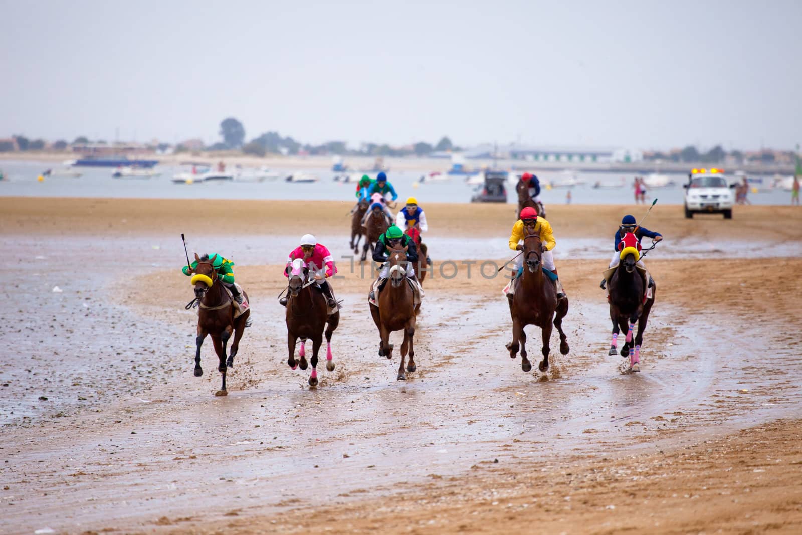 SANLUCAR DE BARRAMEDA, CADIZ, SPAIN - AUGUST 07: Unidentified riders race horses on Sanlucar de Barrameda beach on August 07, 2010 in Sanlucar de Barrameda, Cadiz, Spain.