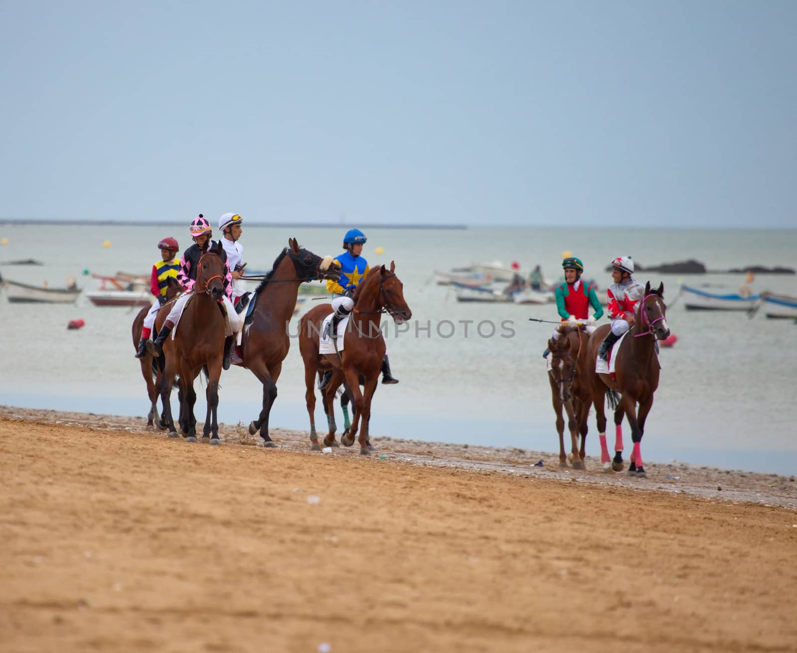 SANLUCAR DE BARRAMEDA, CADIZ, SPAIN - AUGUST 07: Unidentified riders at the start of race horses on Sanlucar de Barrameda beach on  August 07, 2010 in Sanlucar de Barrameda, Cadiz, Spain.