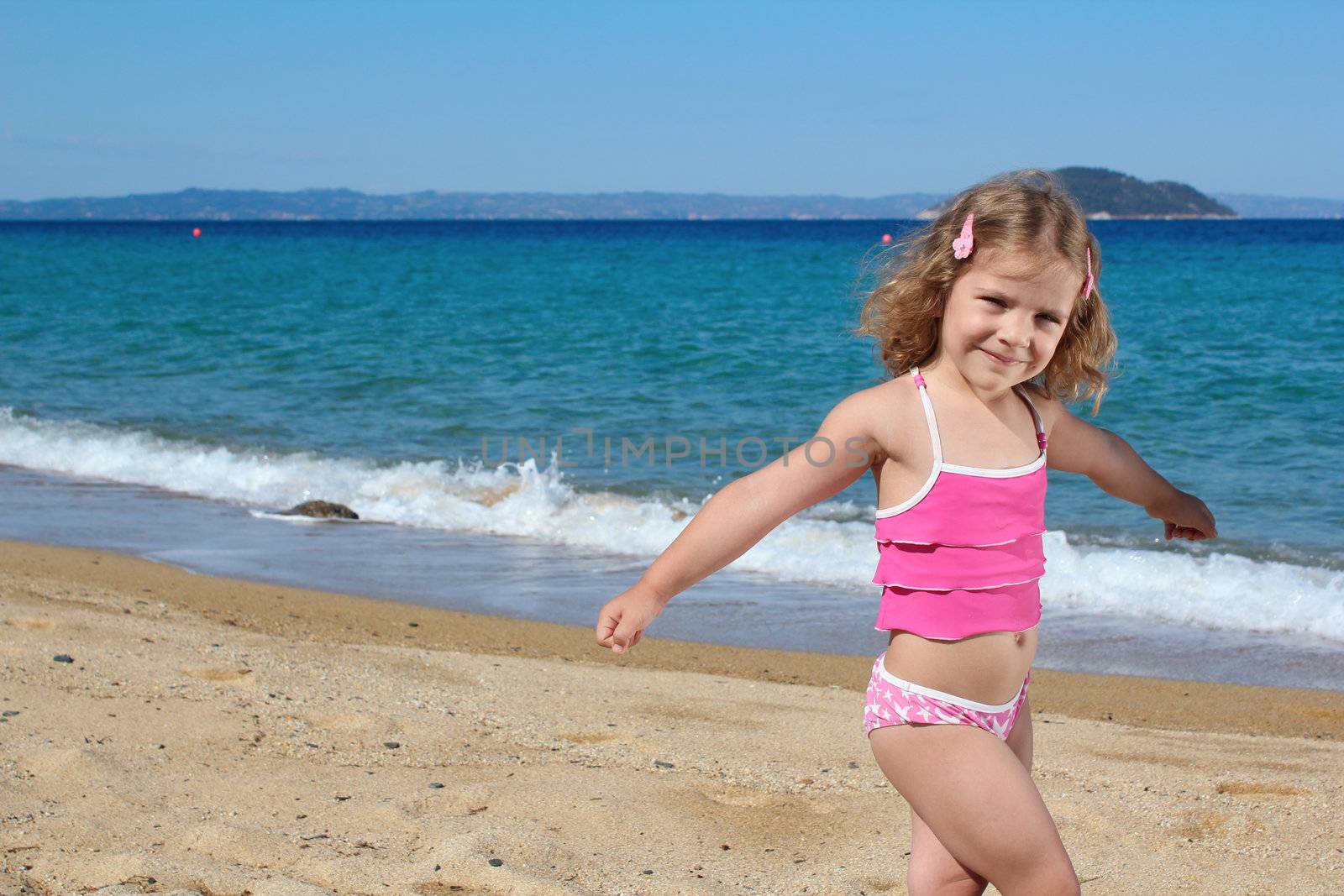 young girl posing on the beach by goce