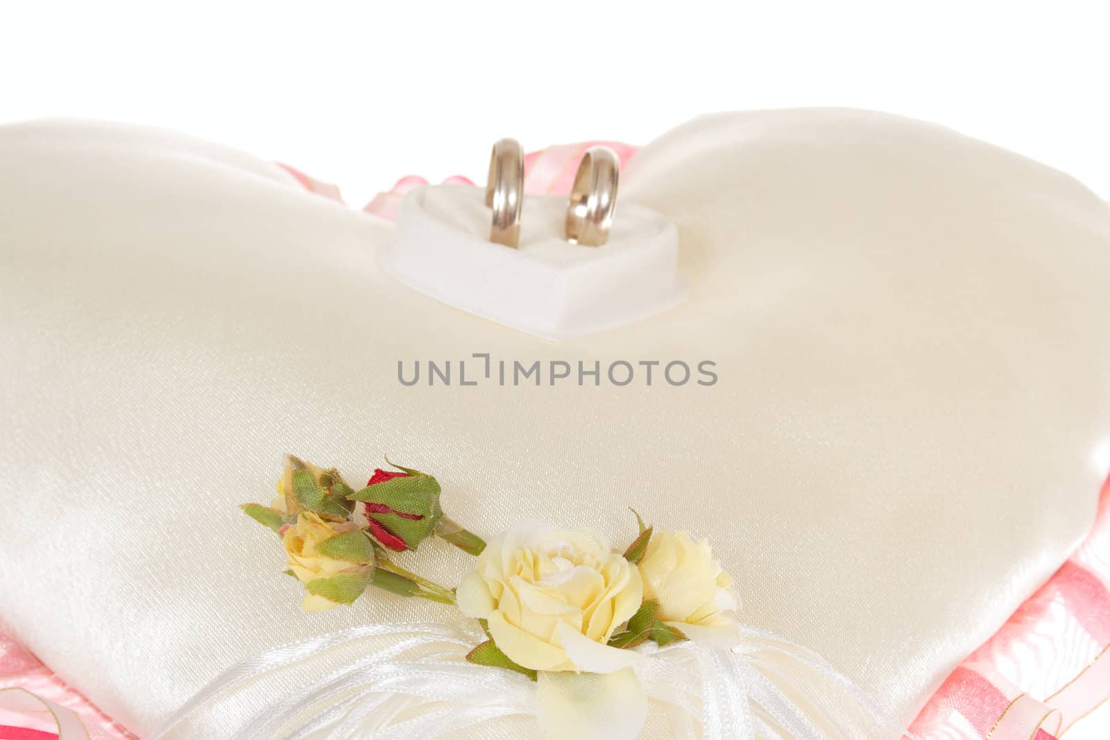 wedding ring on decorative pillow colored photo