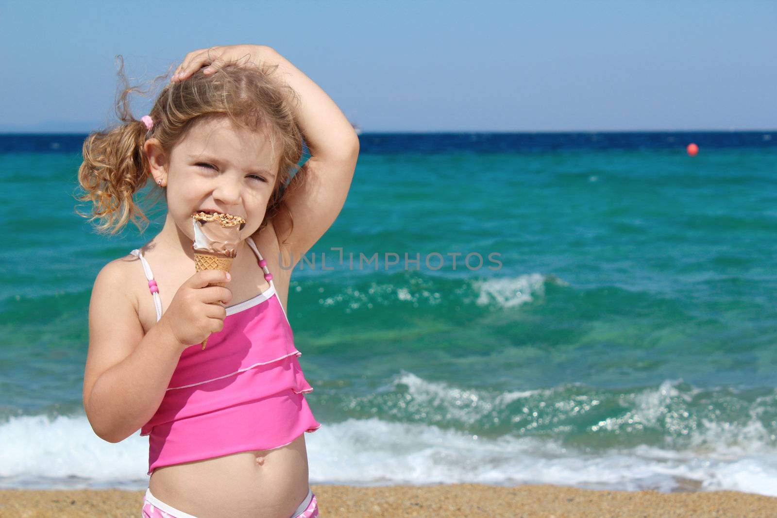young girl with ice cream on the beach by goce