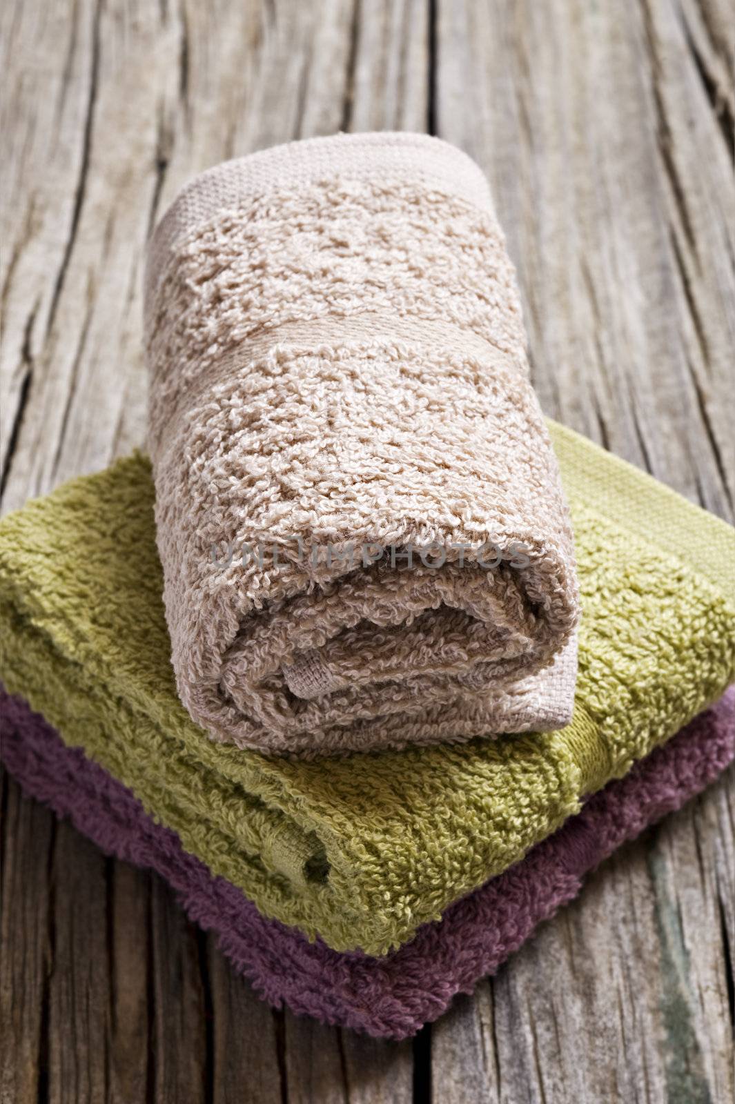 Fresh towels on a rustic wooden surface