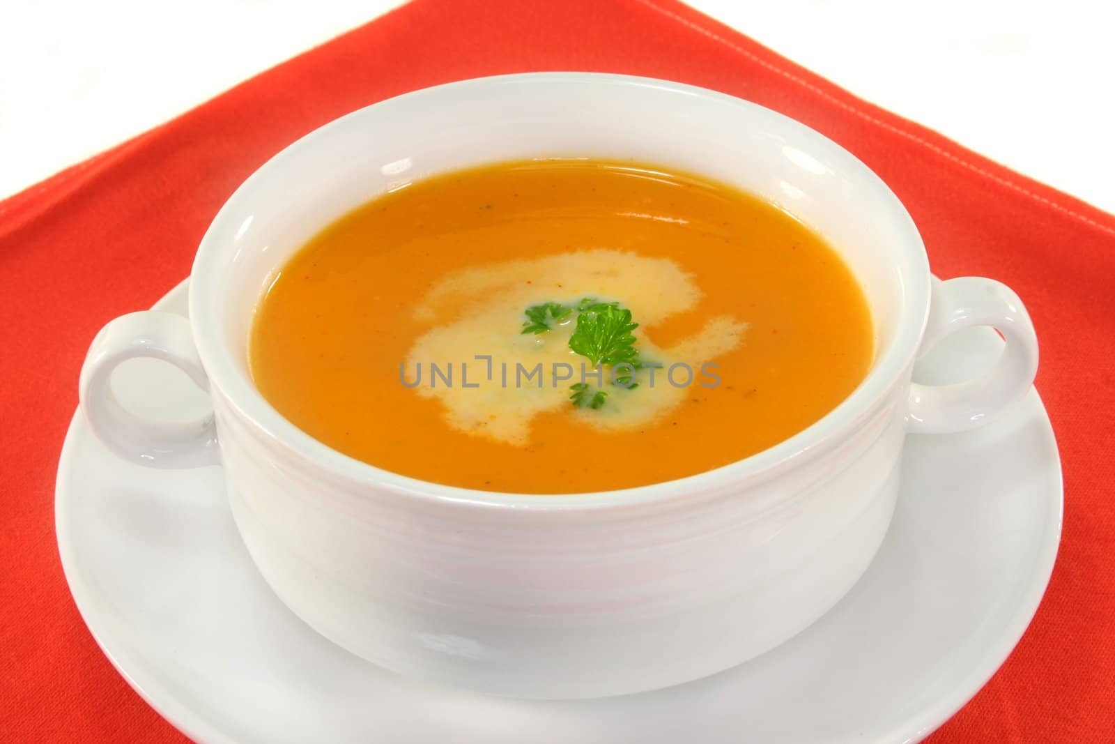 a white Soup cup with fresh pumpkin soup