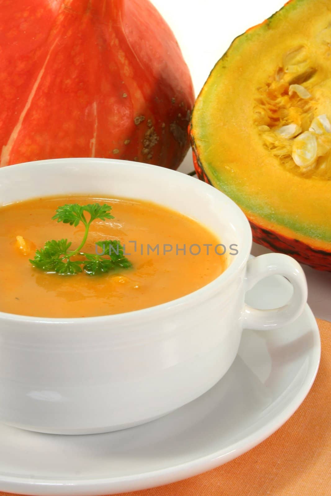 a white Soup cup with fresh pumpkin soup