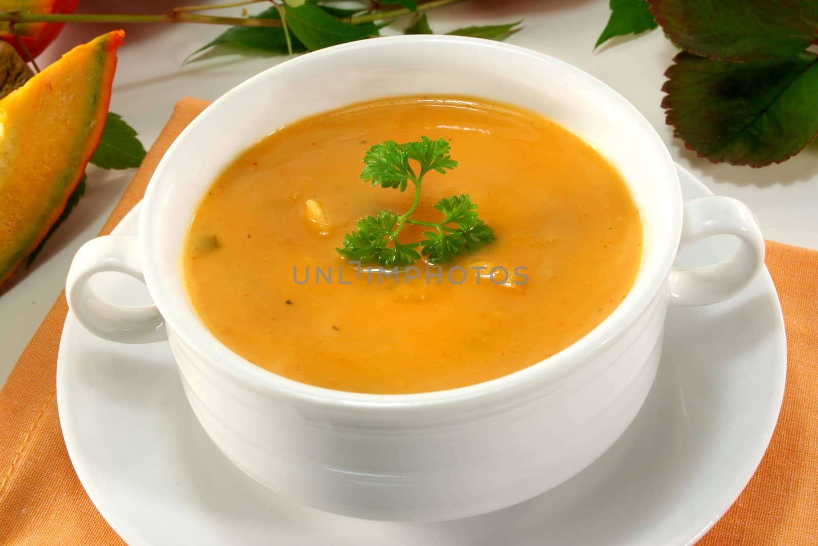 a white Soup cup with fresh pumpkin soup