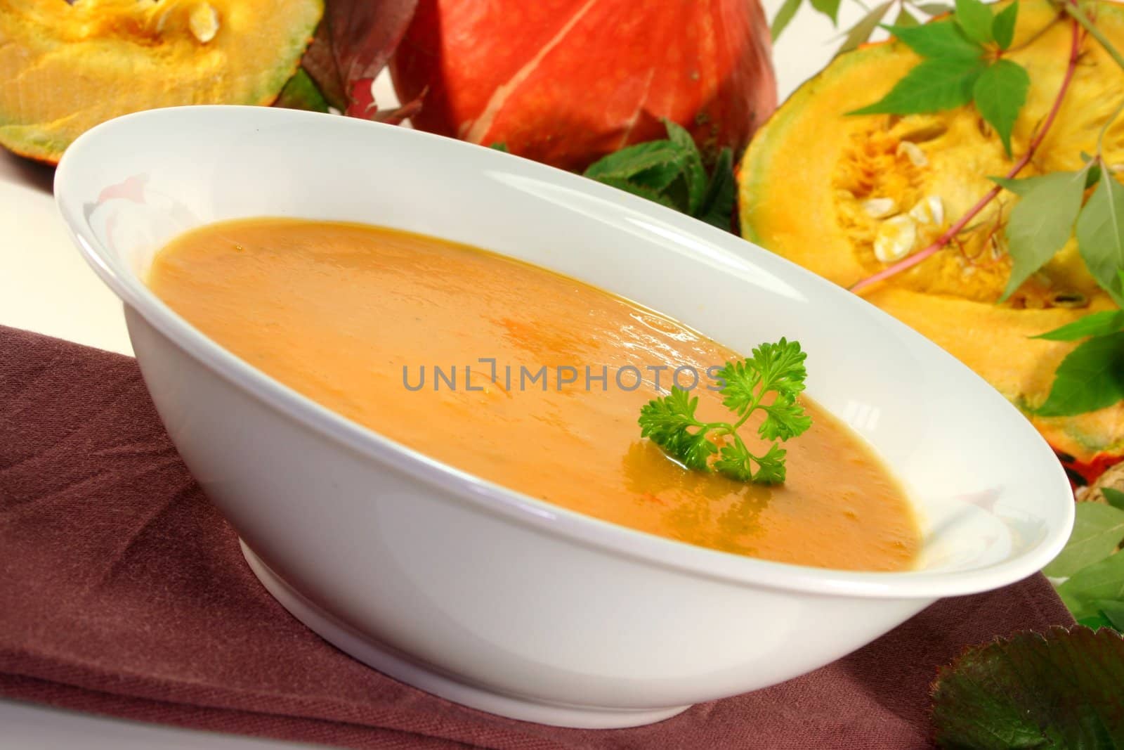 a white plate with fresh pumpkin soup