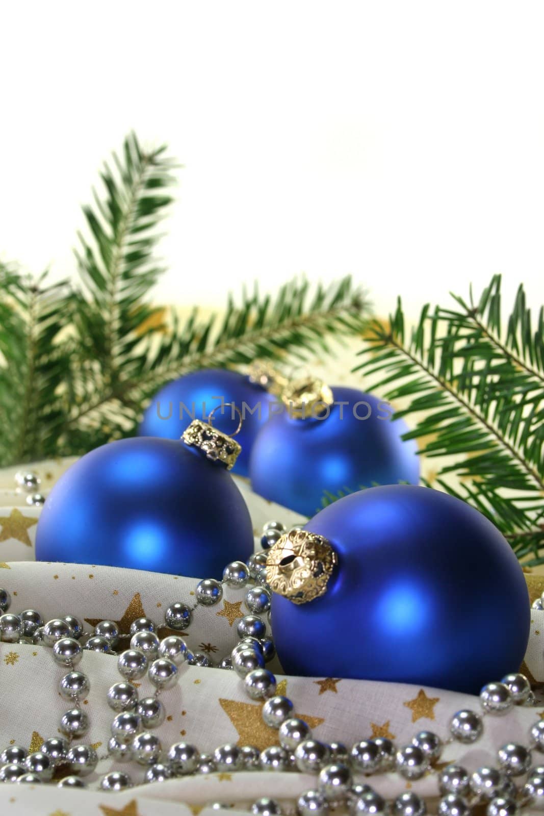 blue Christmas balls and pine branches on Christmas fabric