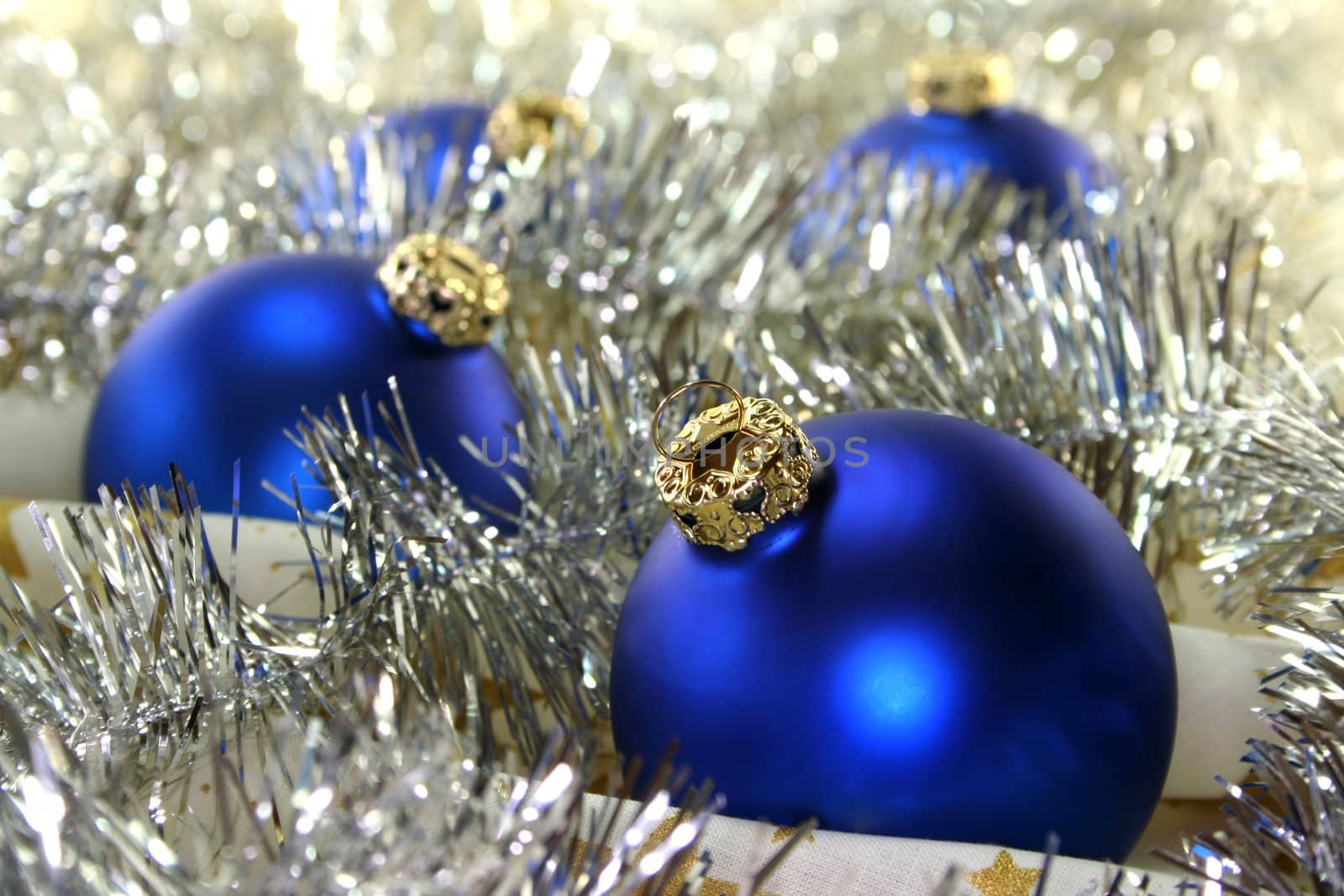 blue christmas ball and pine branches on Christmas fabric