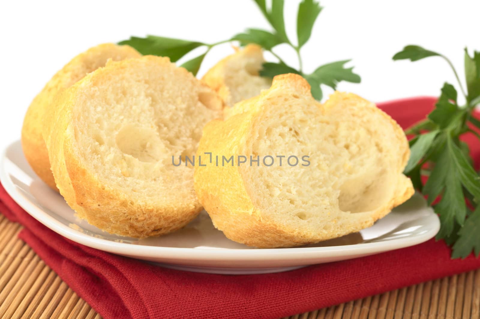 Baguette slices with parsley leaves (Selective Focus, Focus on the front of the bread)