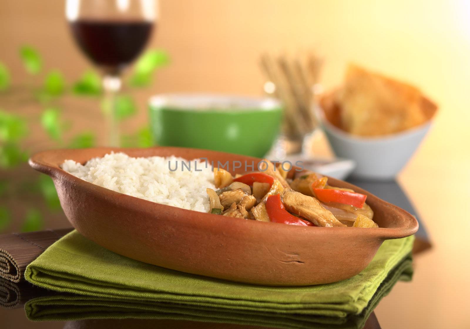 Peruvian food called Lomo Saltado made of meat, bell pepper and onions served with cooked rice (Selective Focus, Focus on the front of the meal)
