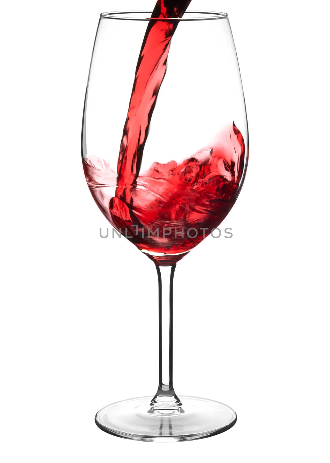 Pouring red wine into wine glass isolated on white 