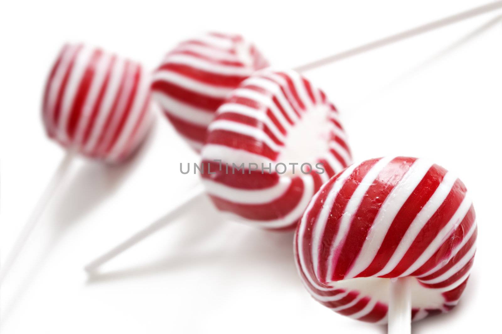 Colorful red lollipops on white background by tish1