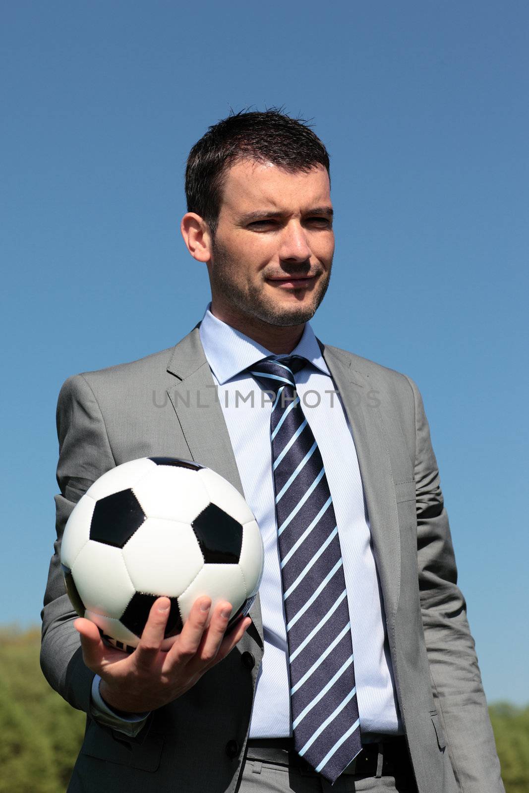 coach with ball in a park in summer