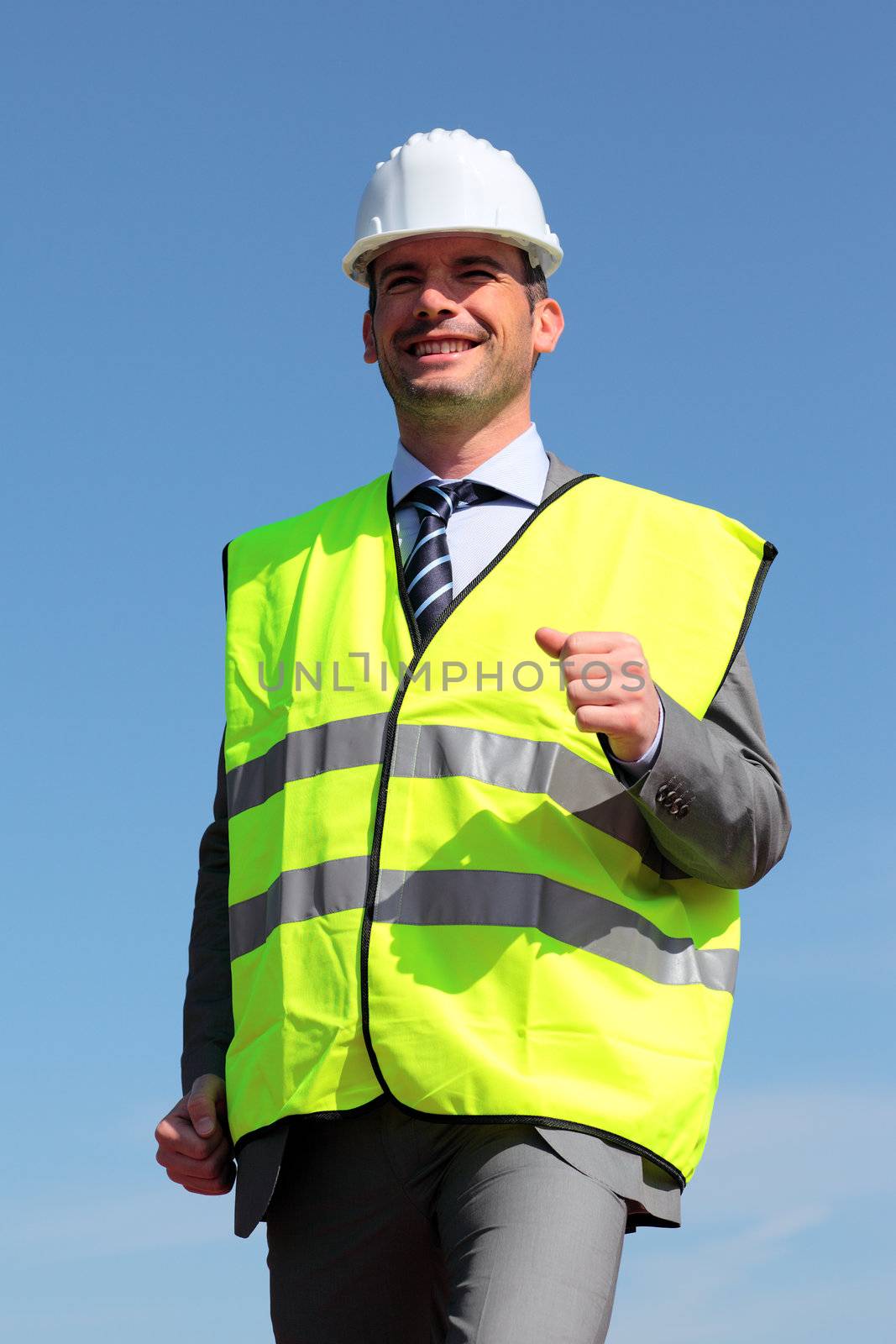 young businessman with hardhat and yellow vest