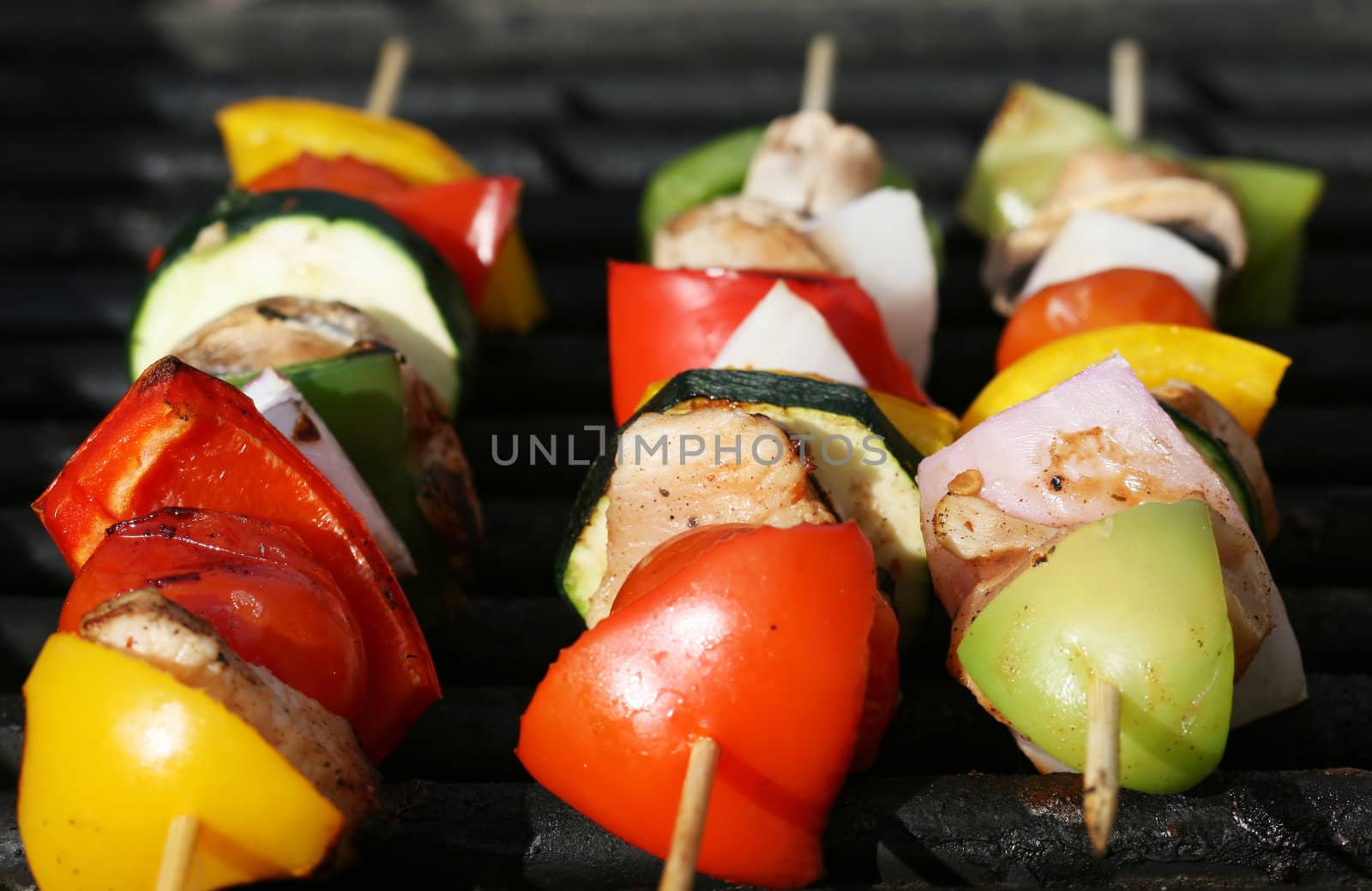 Grilling kabobs during a summer picnic at the park