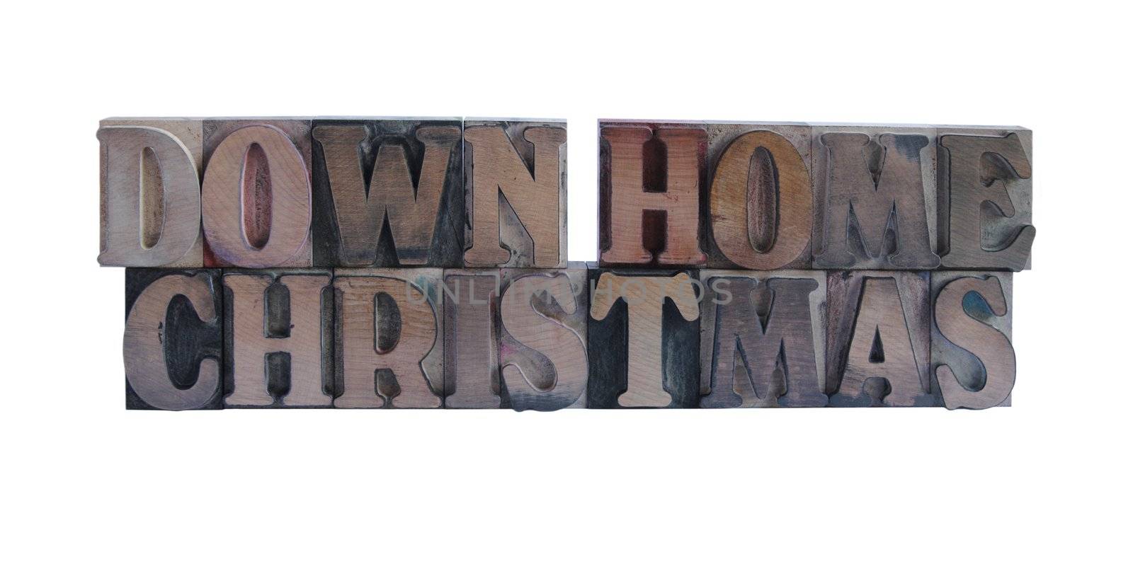 the words 'down home Christmas' in old, ink-stained wood type