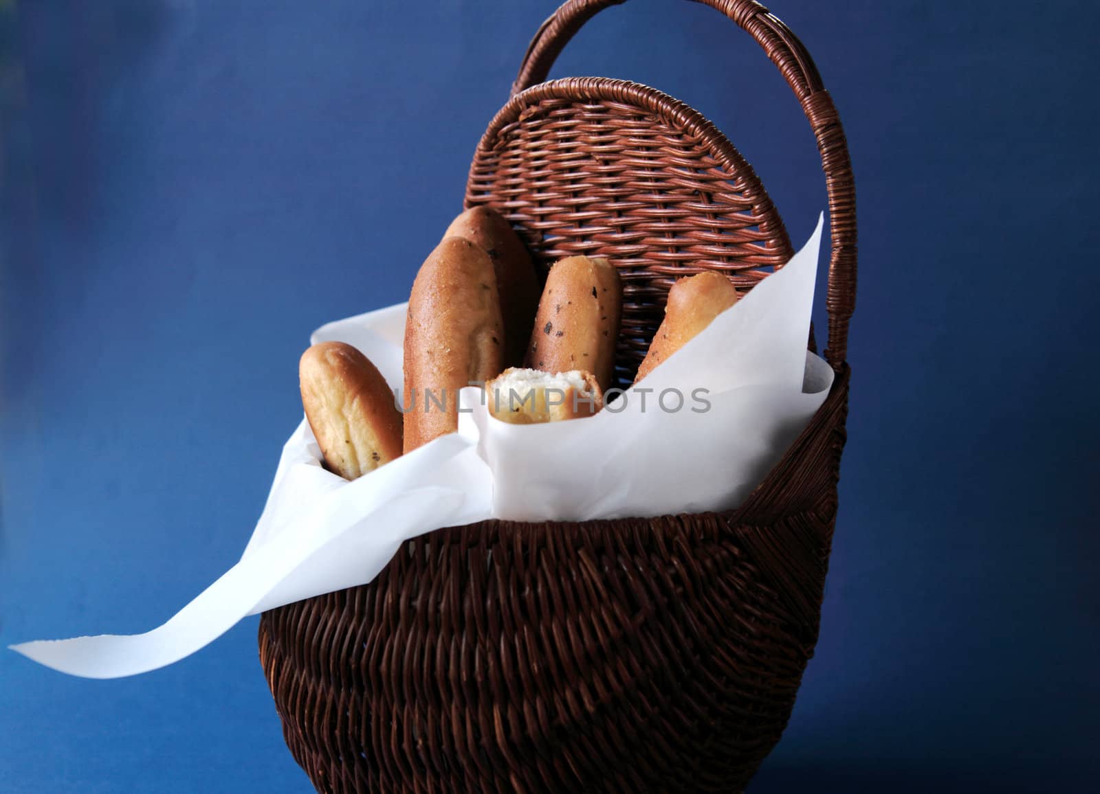 breadsticks in a basket lined with parchment