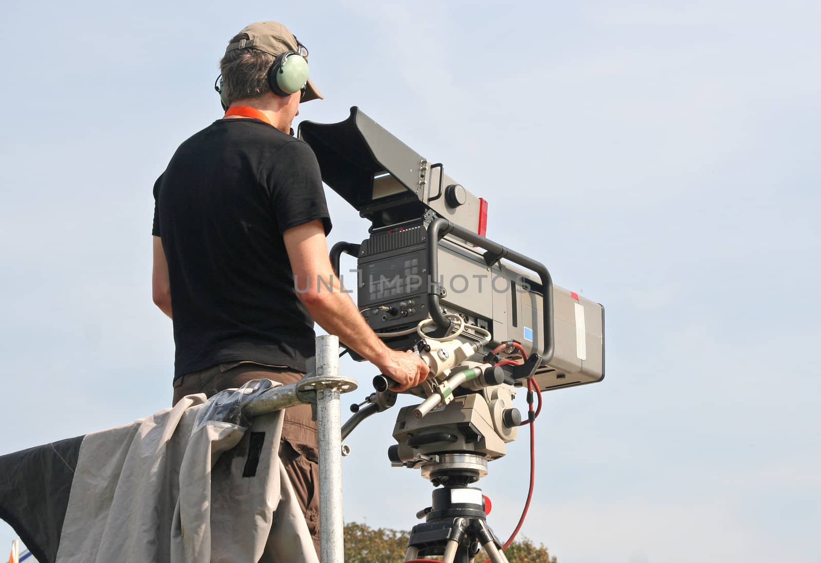 Camera man filming horse jumping competition