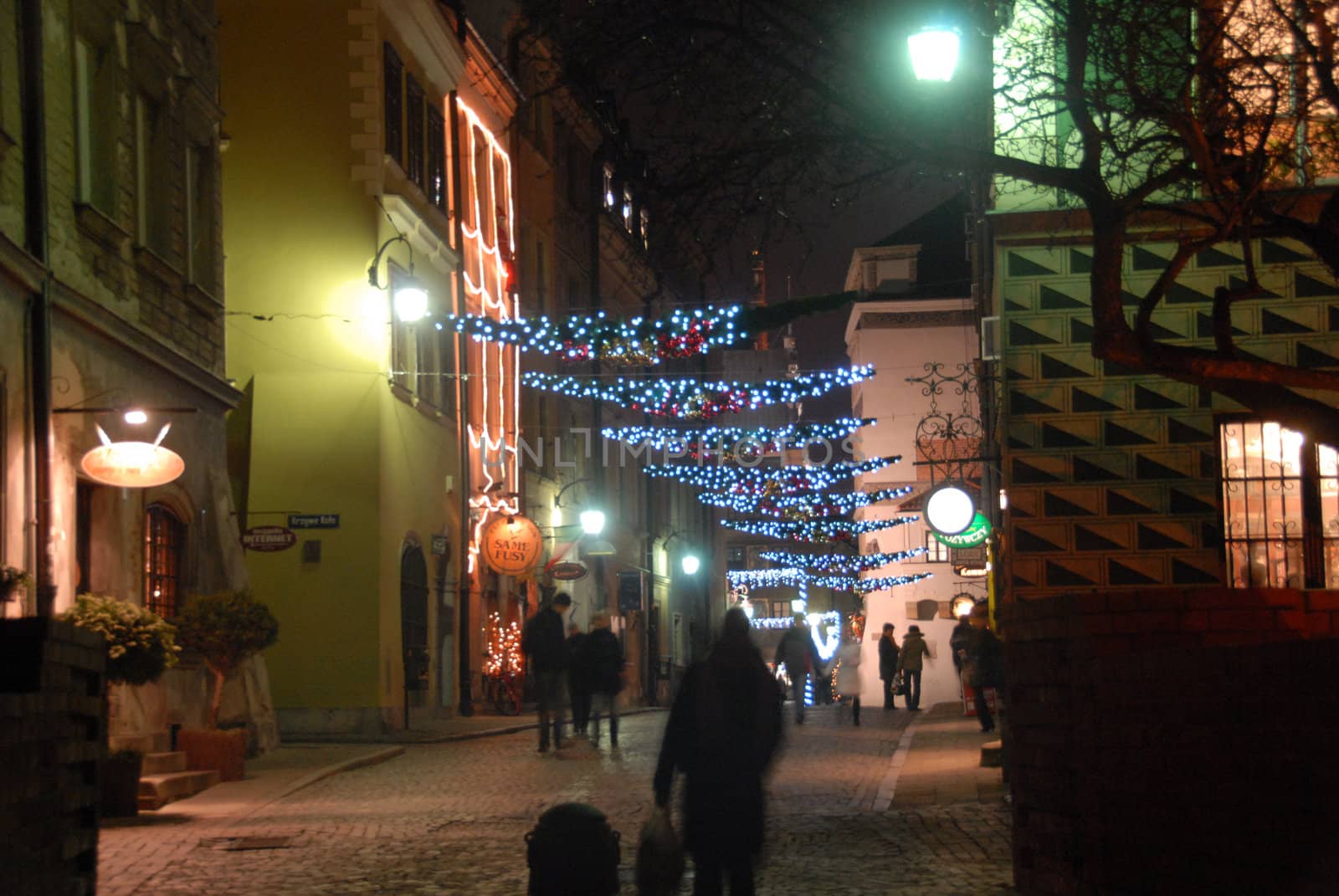 Night view of one of Warsaw old town streets in the night. Christmas decorations.