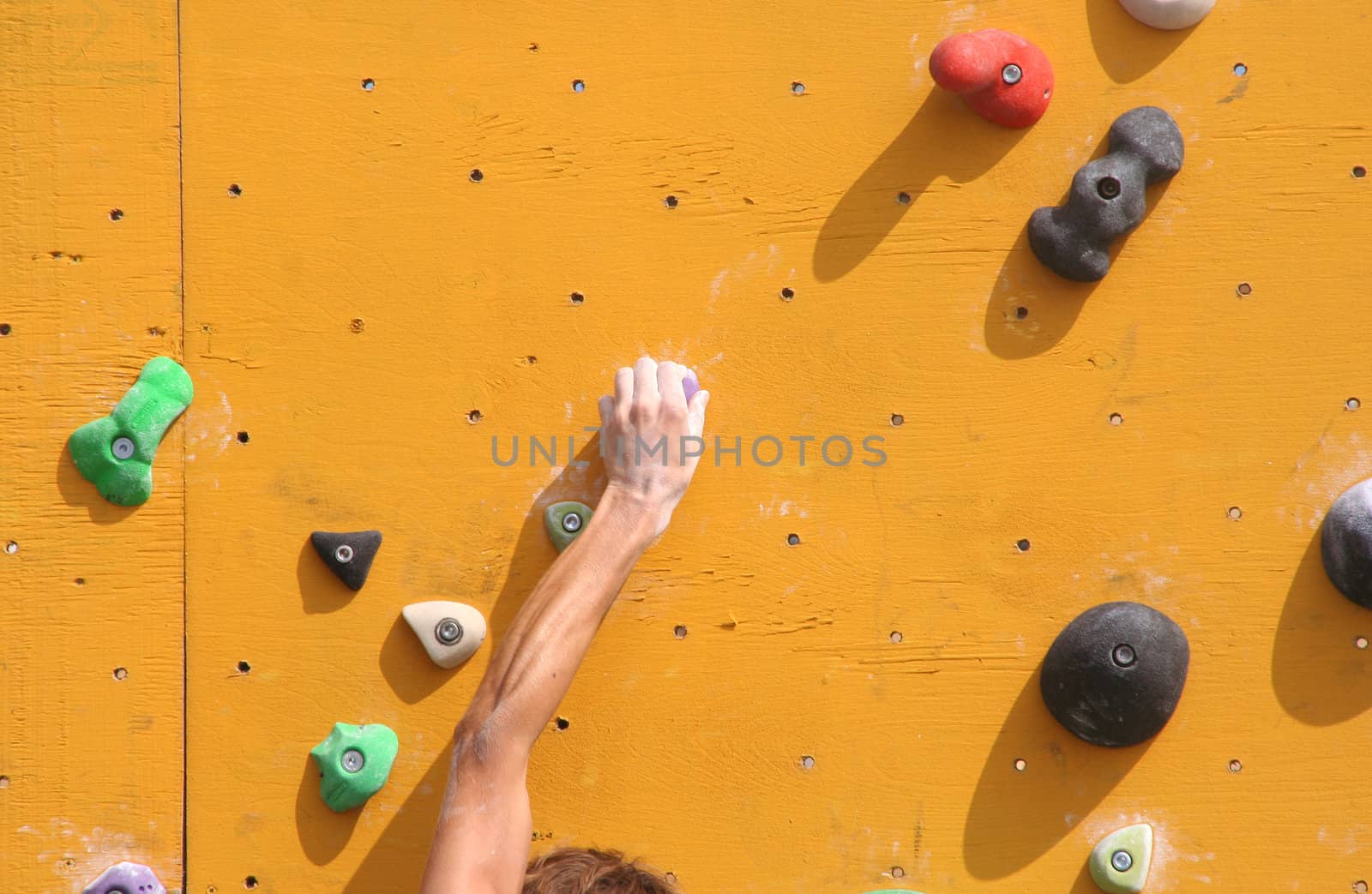 Hand of a climber on a bouldering wall