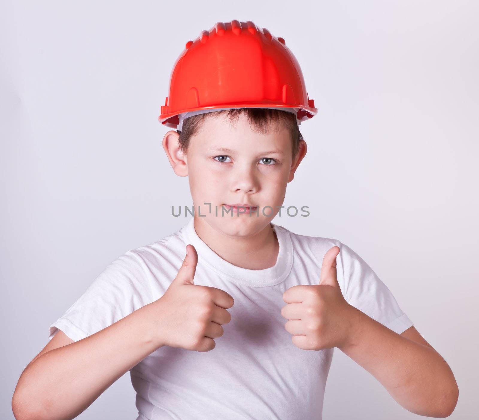 Portrait of a boy in a red protective helmet