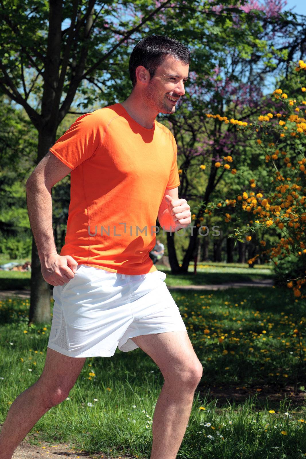 man running in a park in summer