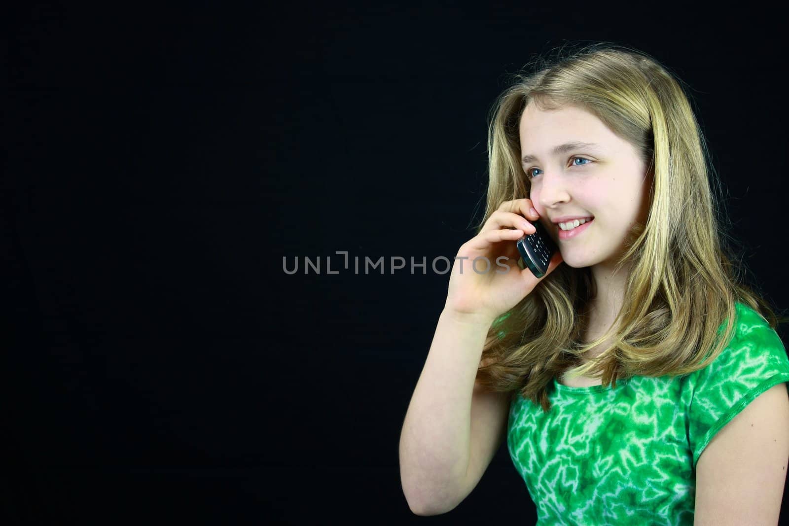 Young Blond haired girl using a cell phone