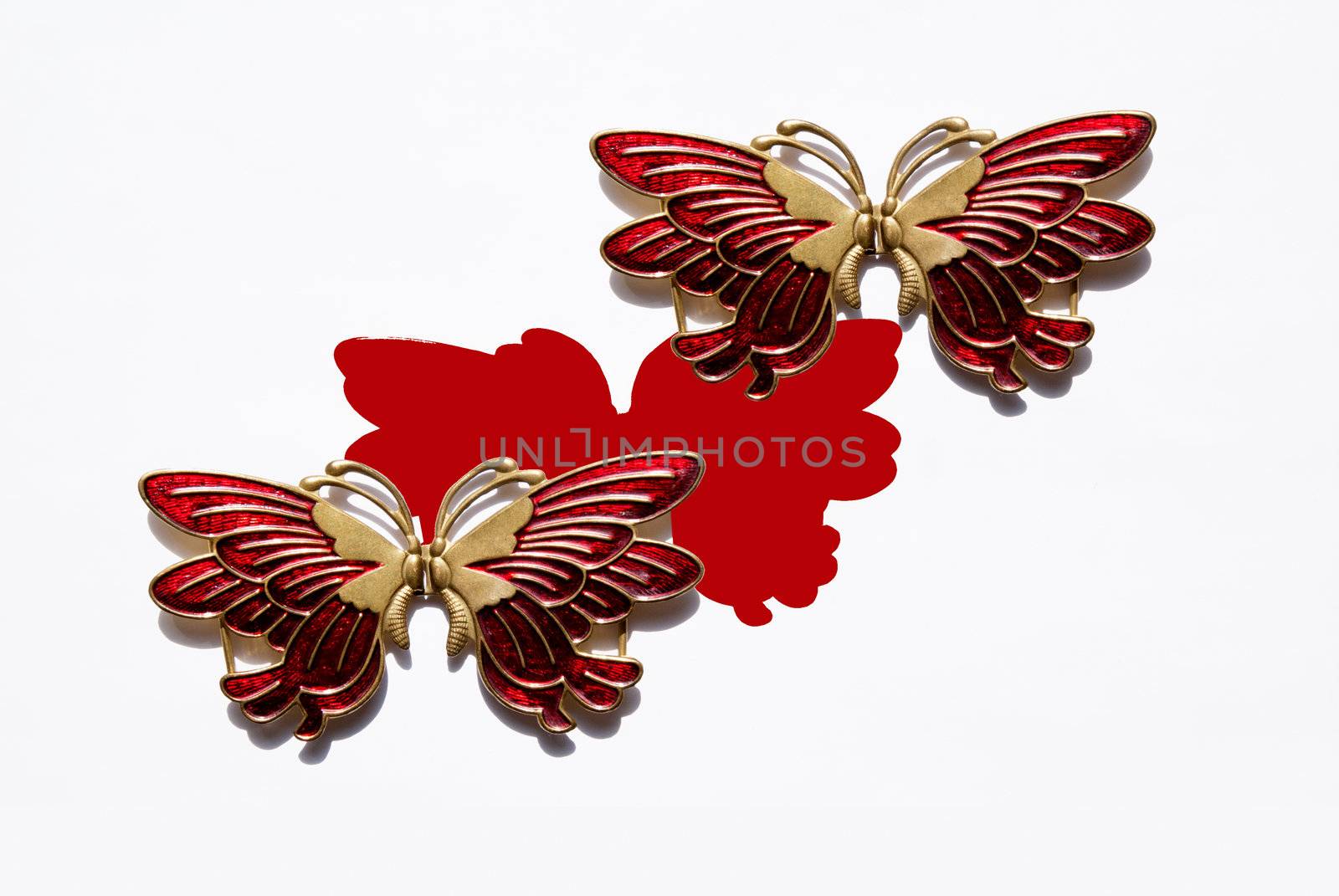 Metallic red with the gold butterfly with the shadow isolated on the white