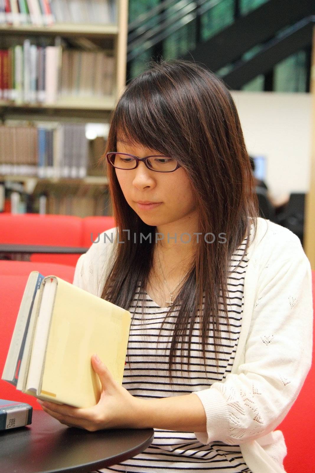 Asian girl student in library