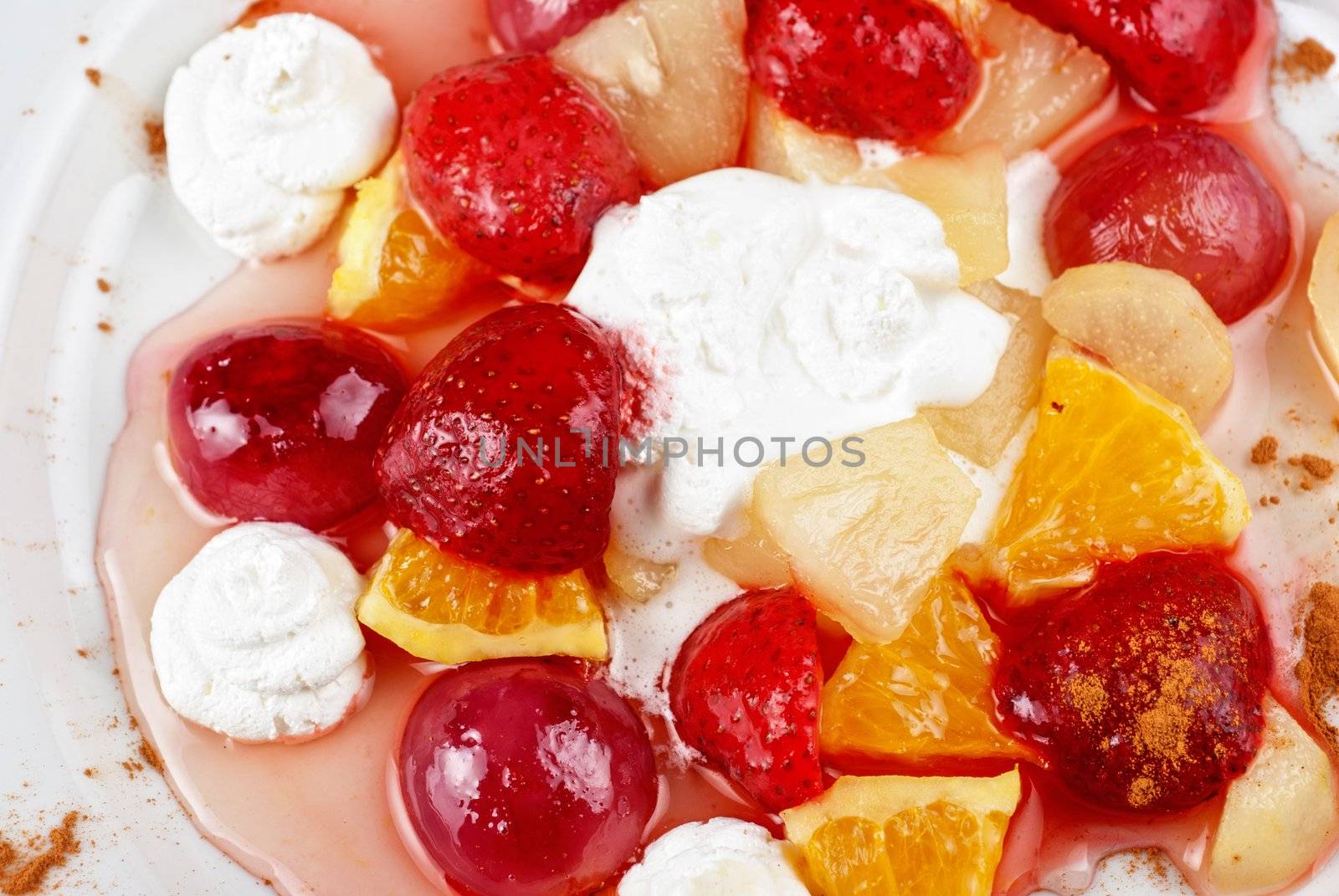 fruit salad of pineapple, grape, orange and strawberry with whipped cream